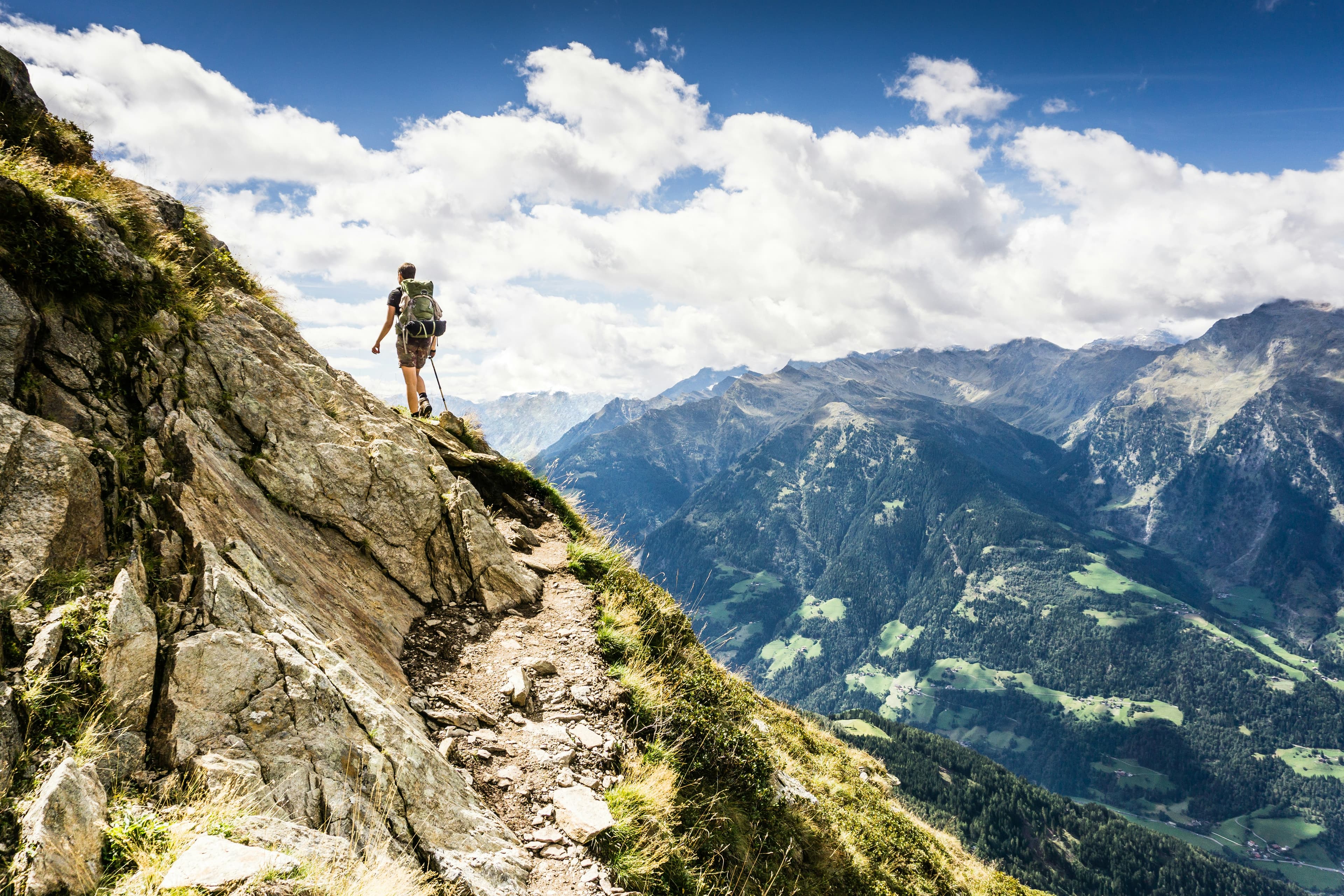 A person standing on a mountaintop, symbolizing the spiritual journey explored in spiritual direction